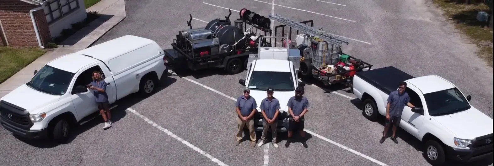 The Beachside Pressure Washing crew with their trucks and wash trailers